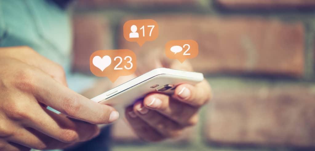 User checks phone for social media engagement
